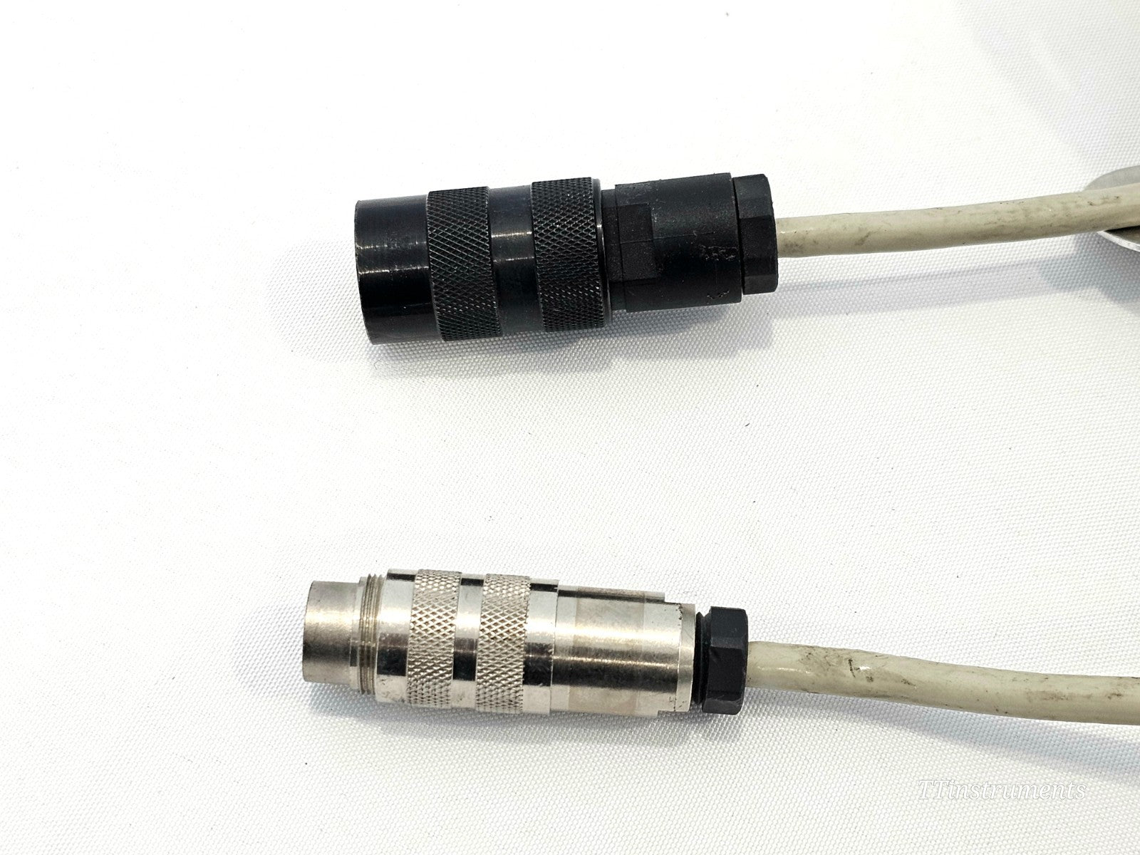 Aeroflex IFR Marconi 54311-113Y both cable ends side by side — black female socket (top) and silver male plug (bottom)