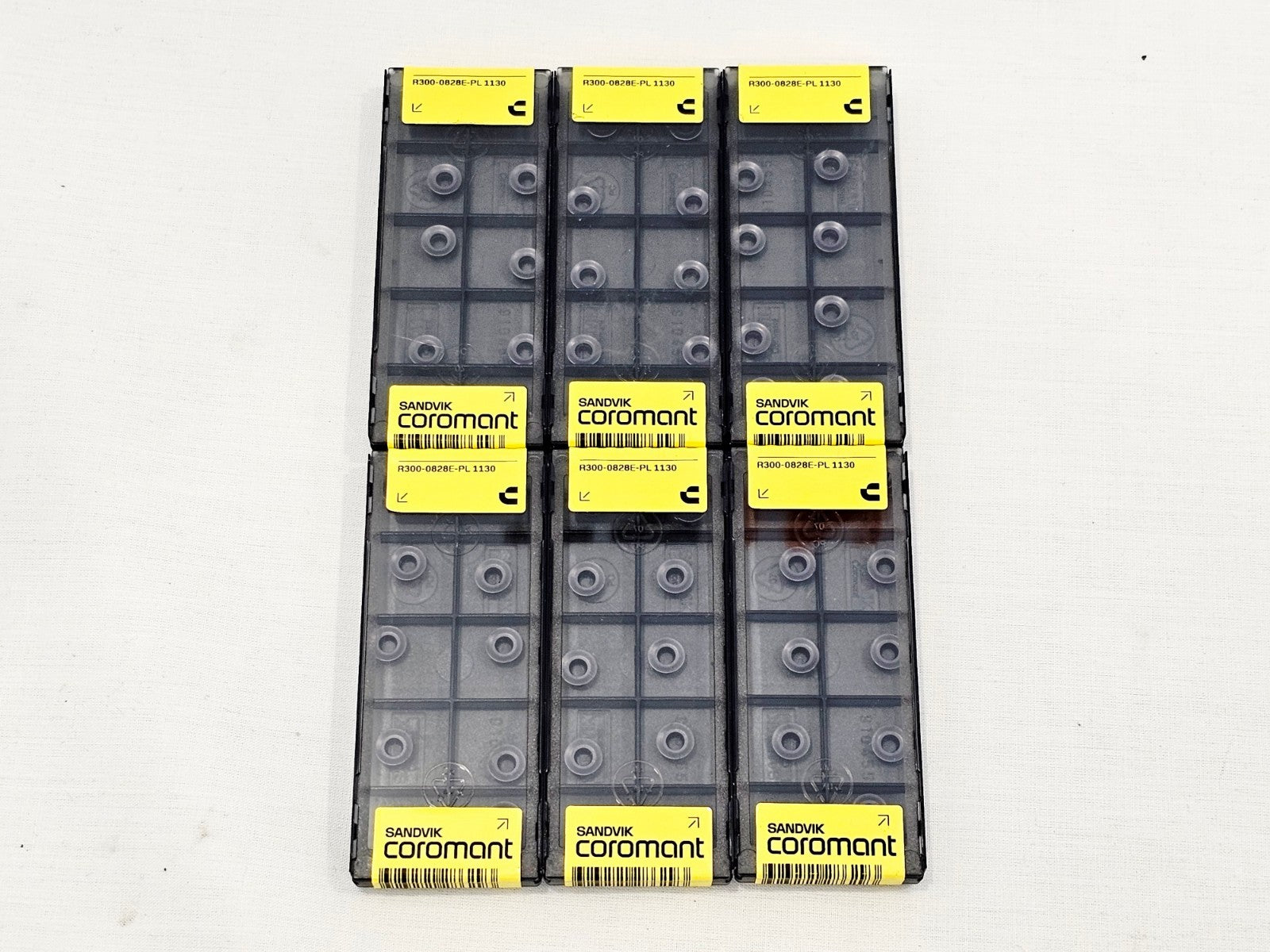 Six sealed Sandvik Coromant R300-0828E-PL 1130 CoroMill 300 insert packs arranged in two rows of three