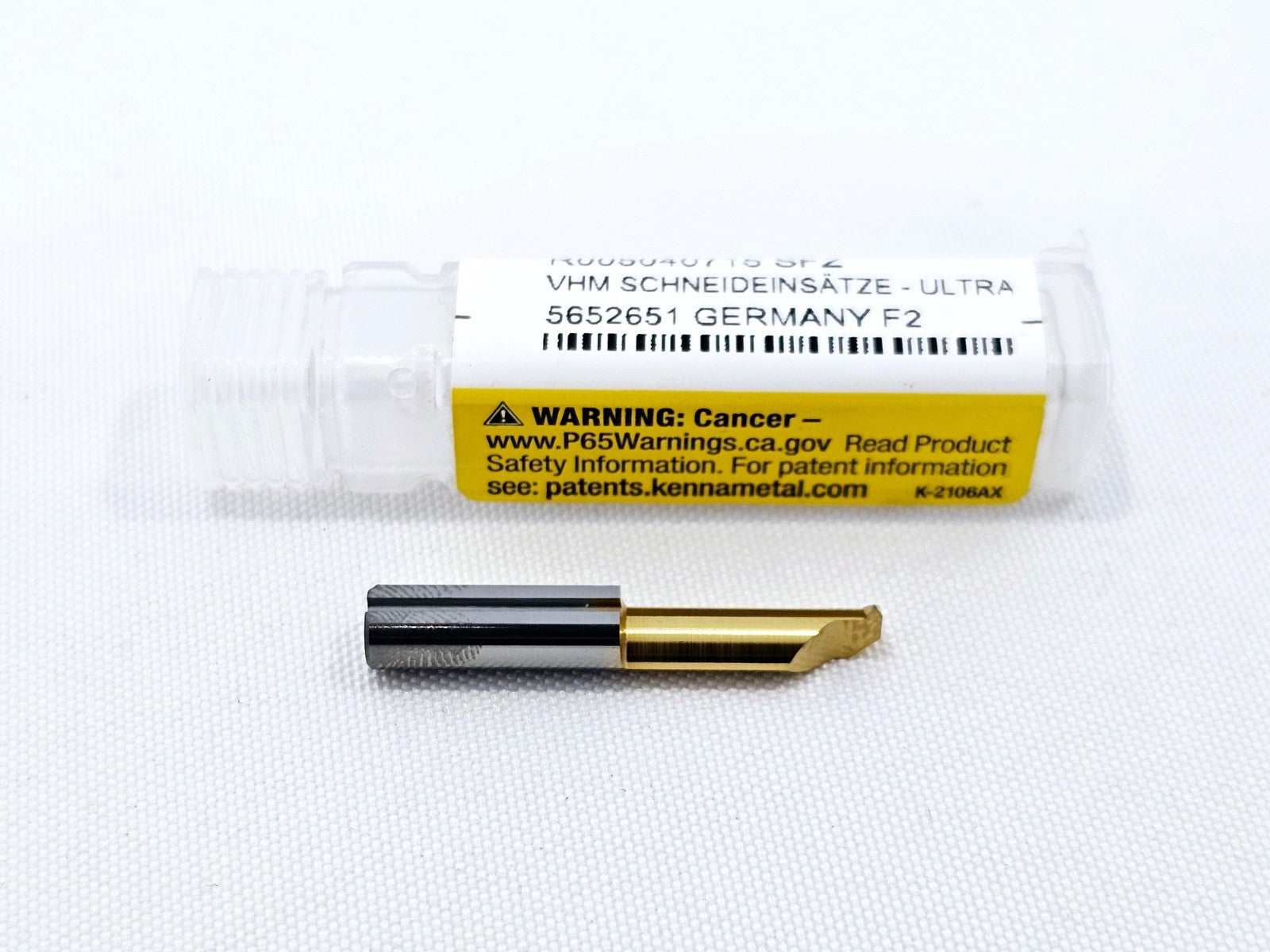 Kennametal R005040715 SFZ solid carbide threading insert removed from vial showing TiN-coated cutting tip