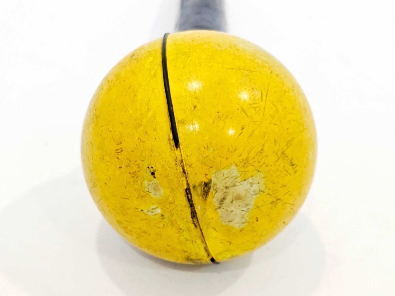 Narda 3501/03 yellow isotropic antenna ball close-up showing wear, surface scratches, and paint loss with seam detail