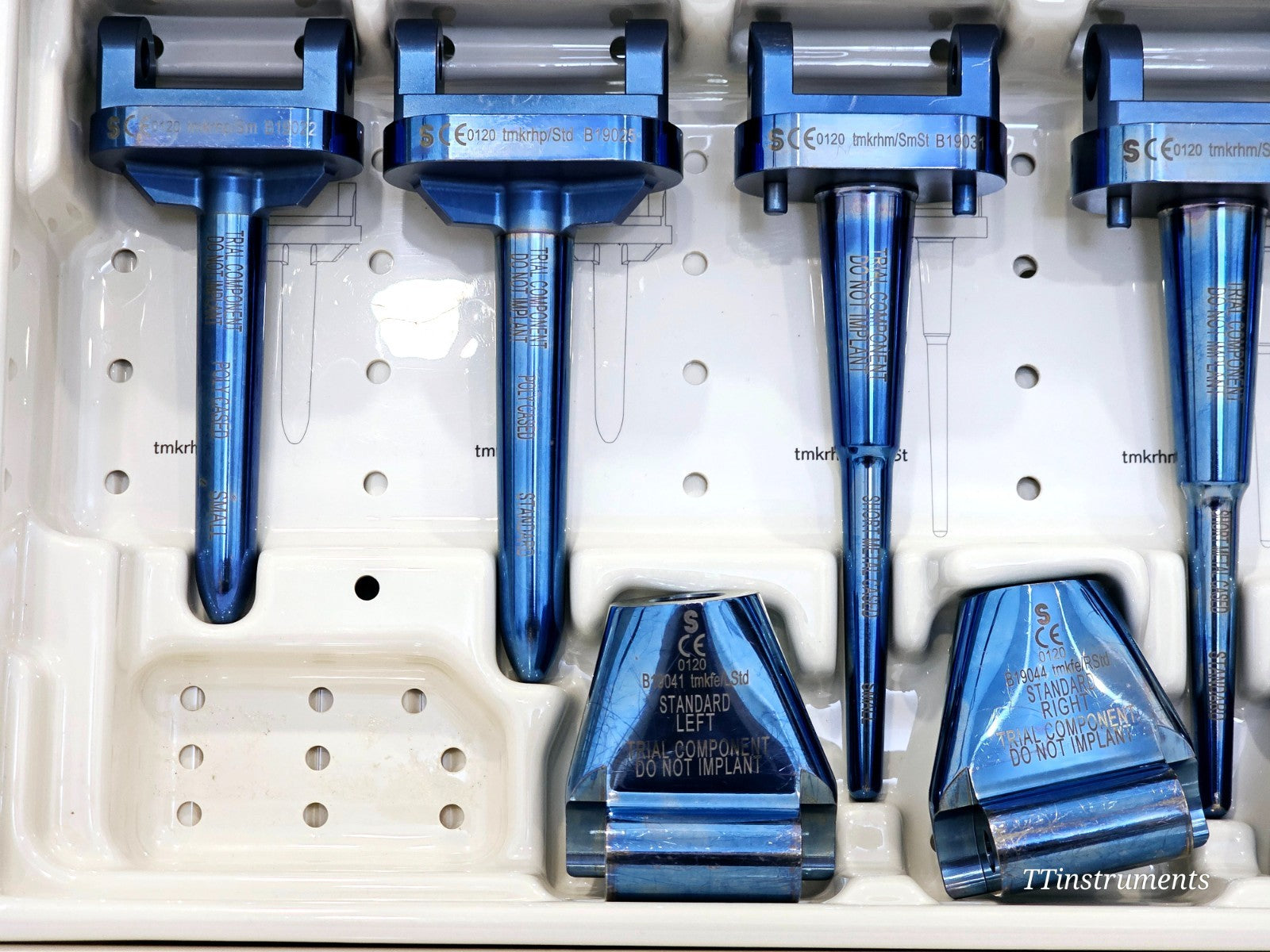 Stanmore METS upper tray close-up showing four trial stem handles and Standard Left and Standard Right trial femoral body components