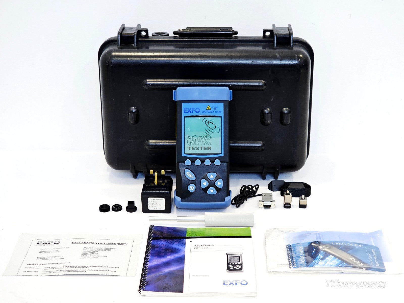 EXFO FOT-922 MaxTester full kit laid out showing unit, case, AC adapter, cables, manuals and Declaration of Conformity