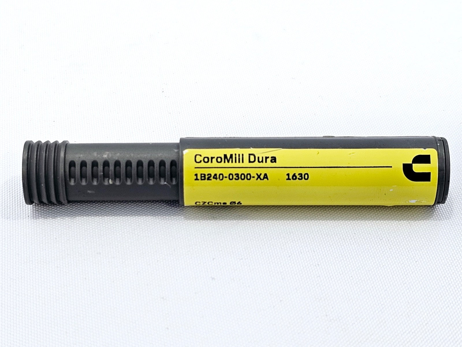 Sandvik Coromant CoroMill Dura 1B240-0300-XA 1630 storage tube showing product name and grade label close-up