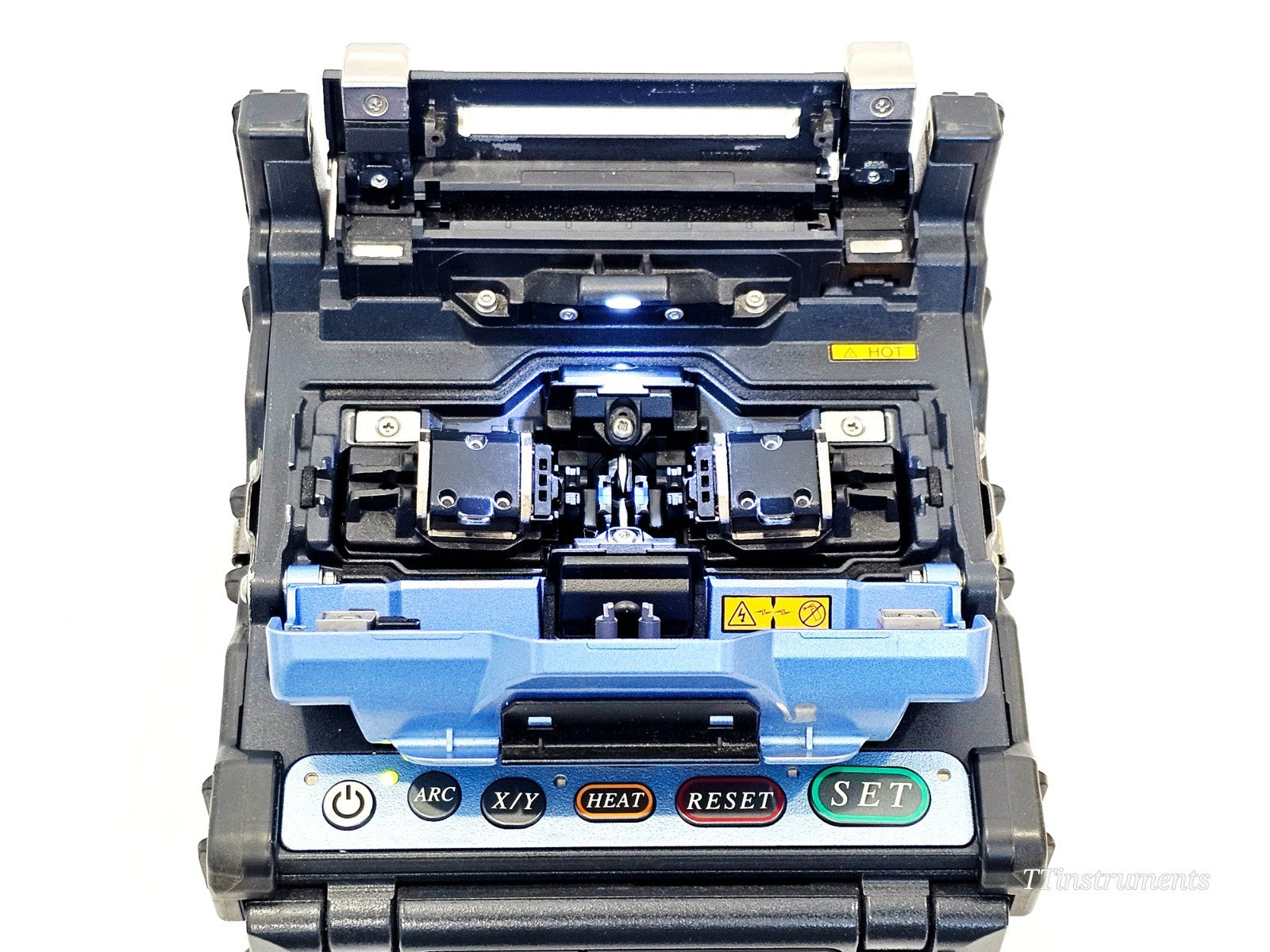 Fujikura FSM-62S+ top-down view showing fibre clamp V-grooves, electrodes and wind protector open ready for splicing