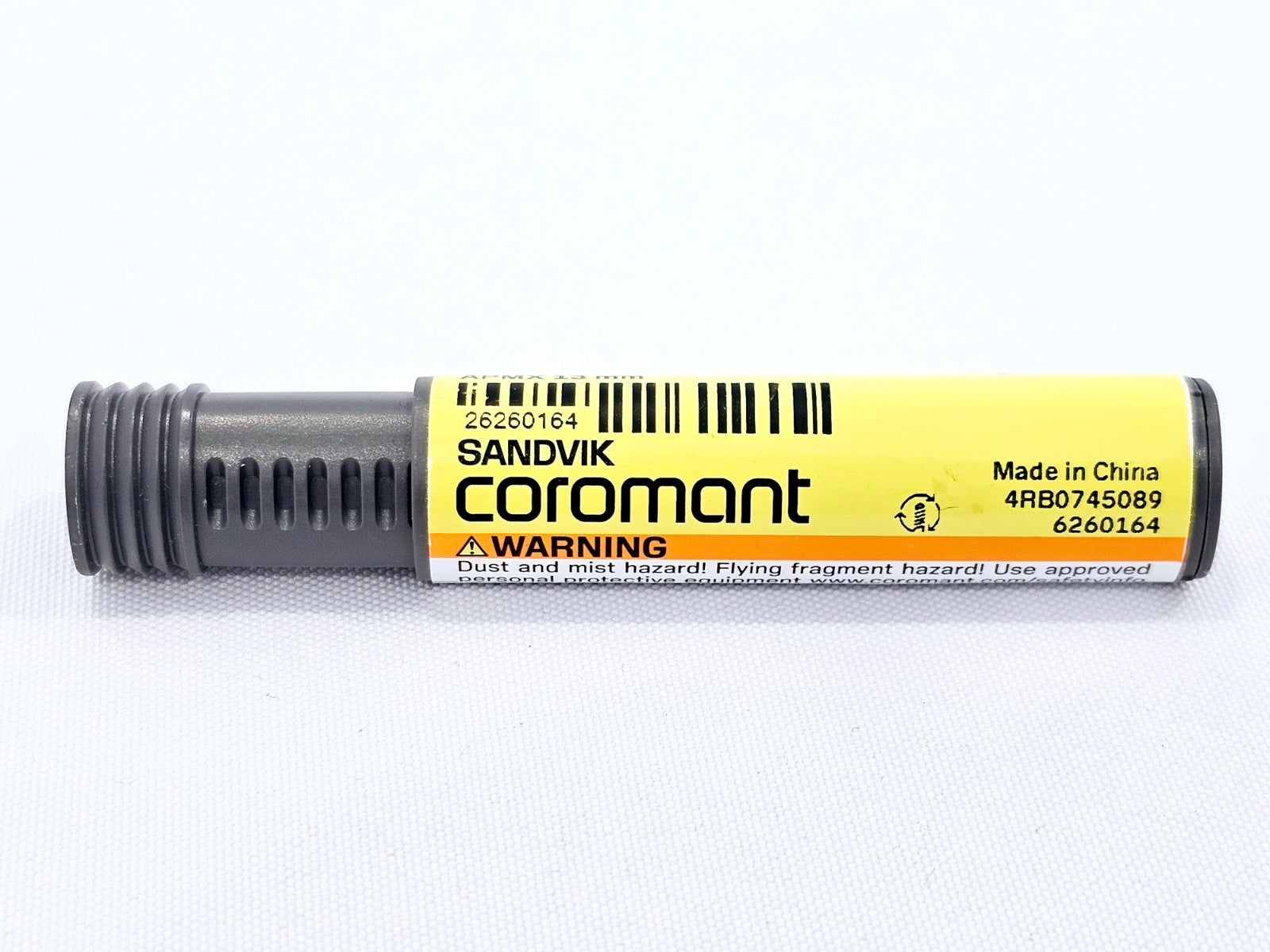 Sandvik Coromant CoroMill Plura grey cylindrical canister with yellow label showing warning text, 4RB0745089 and Made in China