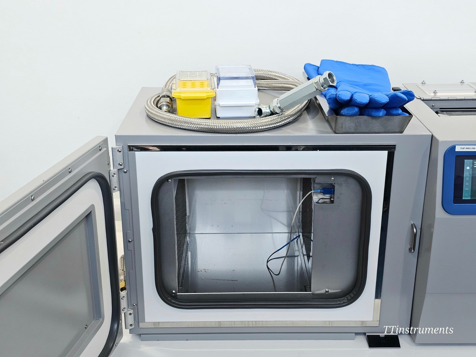 CryoMed TSCM34PV freezer chamber door open revealing stainless steel interior, LN2 injection ring system and blue thermocouple connector port