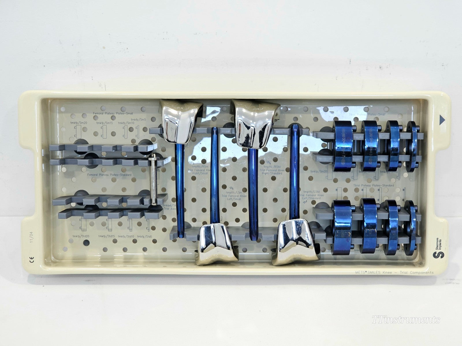 Stanmore METS SMILES Knee Trial Set lower tray showing chrome femoral knee trials, tibial plateau plate trials Small and Standard, and tibial insert trials