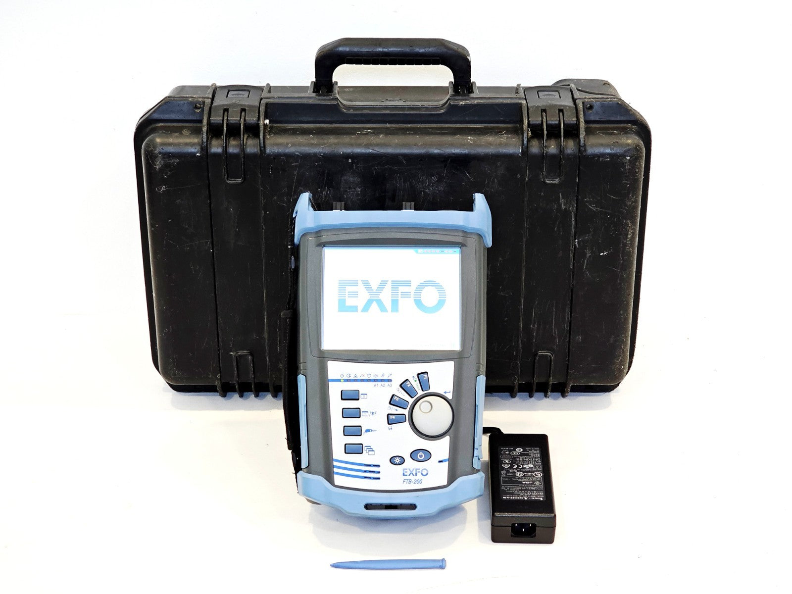 EXFO FTB-200 with FTB-7200D OTDR shown with hard carry case, power adapter and stylus on white background