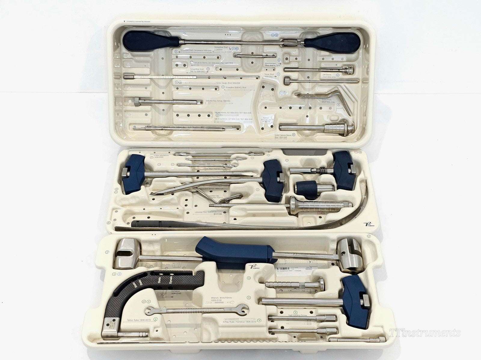 Stryker T2 Humerus full instrument set — container open showing all three tray levels with screwdriver shafts, drill sleeves, targeting arm, reamers, hammers and guide wires