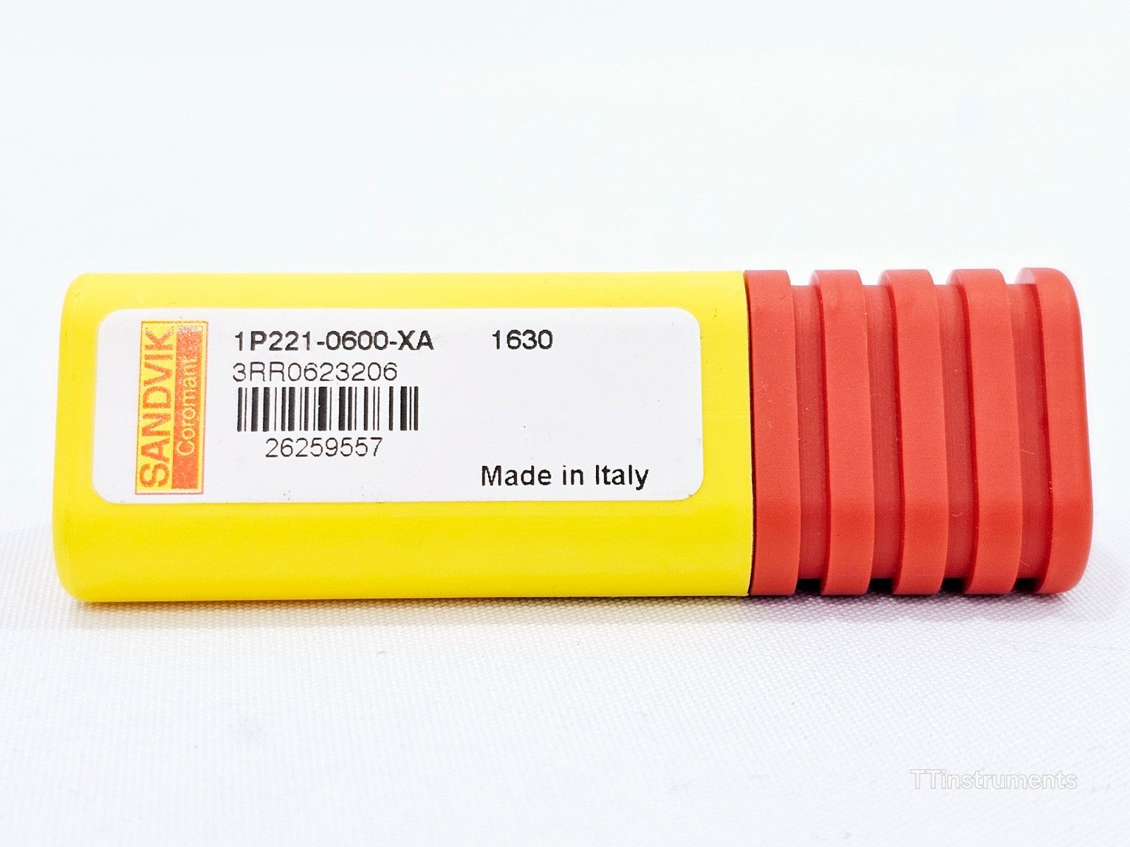 Sandvik Coromant CoroMill Plura 1P221-0600-XA 1630 — side view of yellow/red hard case with barcode label, Made in Italy
