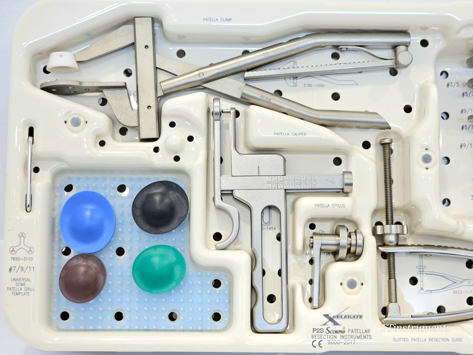 Stryker Scorpio Patellar Resection Instruments tray close-up showing patella clamp, patellar caliper, patellar stylus, four colour-coded dome drill templates, and P2S Xcelerate label on tray base