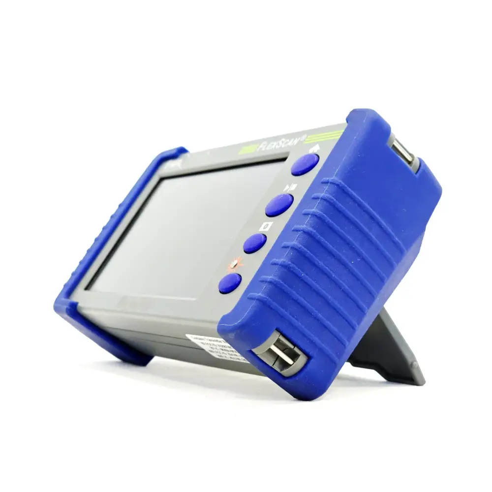 AFL FlexScan FS300-325 OTDR angled front-left view showing touchscreen, side navigation buttons, USB port and kickstand
