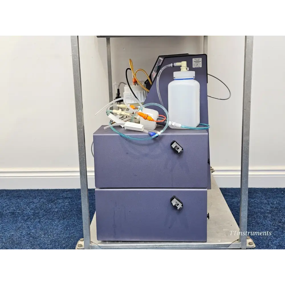 BD FACSCelesta trolley lower shelf showing waste container, tubing manifold, Accuri bottle and fluidics connections