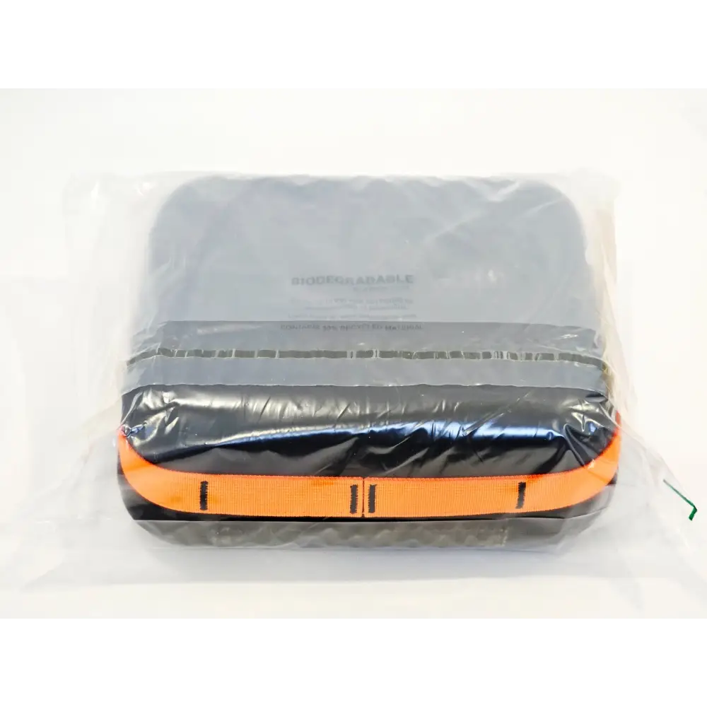 Occuity PM1 pachymeter carry case in biodegradable sealed polybag, showing orange zip trim and dark grey case back
