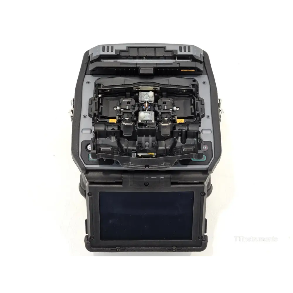 Fujikura 90S+ fusion splicer open wind protector showing V-groove fibre loading stage and electrodes
