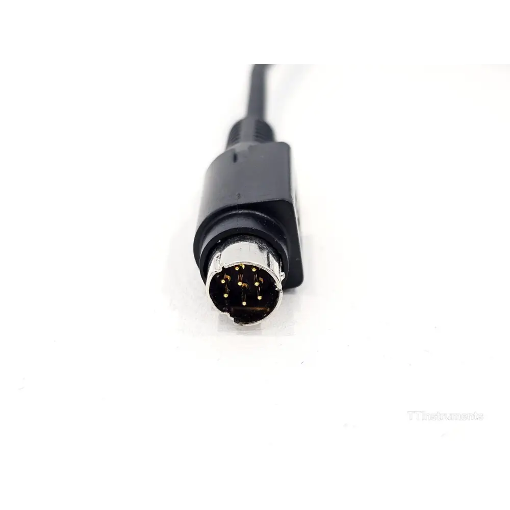 EXFO FIP-400 coiled cable 8-pin mini-DIN plug close-up showing gold-plated pins for EXFO legacy platform connection