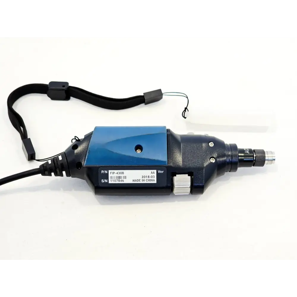 EXFO FIP-430B probe underside showing serial number label S/N 1107846, version AA, dated 2018-03, with wrist strap
