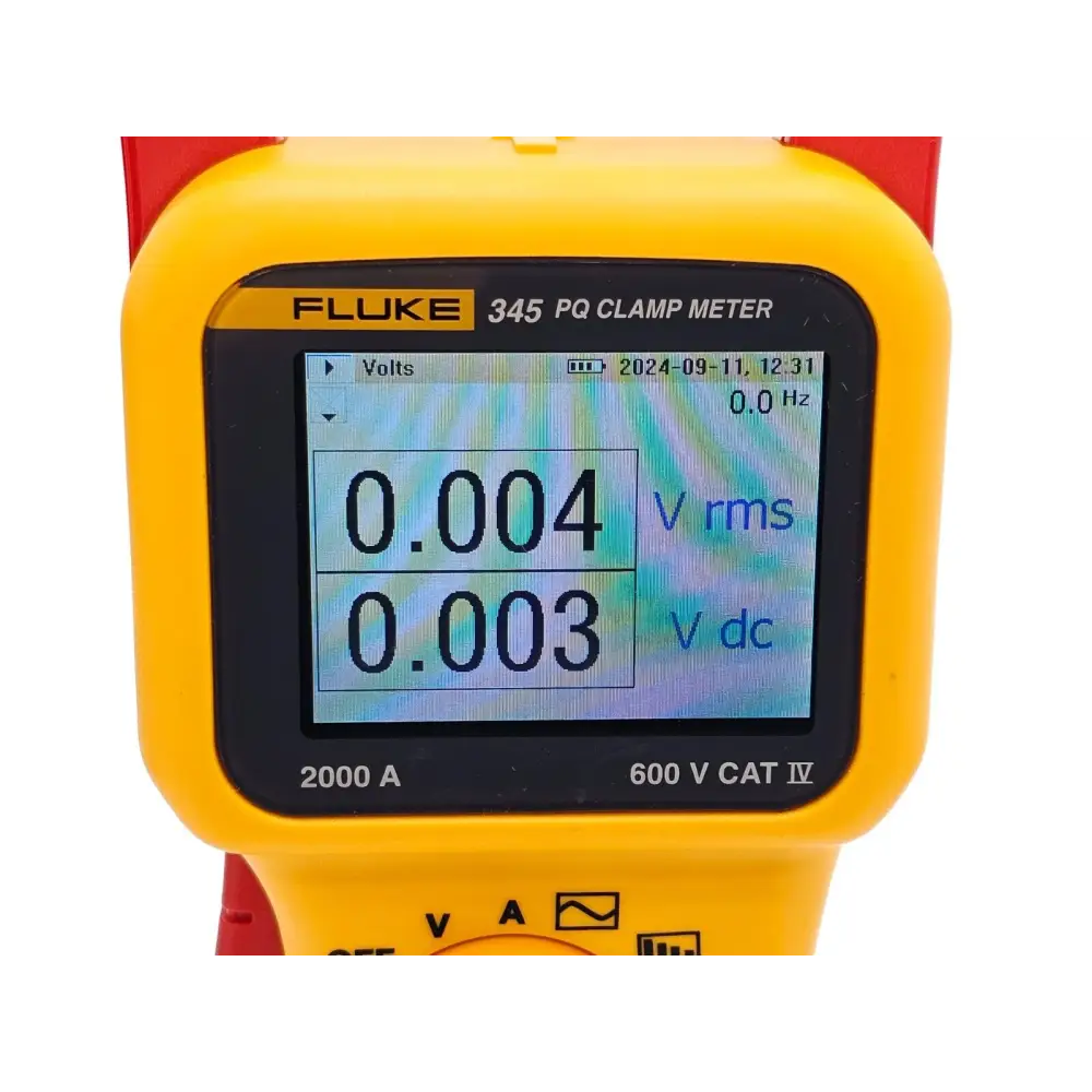 Fluke 345 power quality meter positioned on work surface with test leads connected