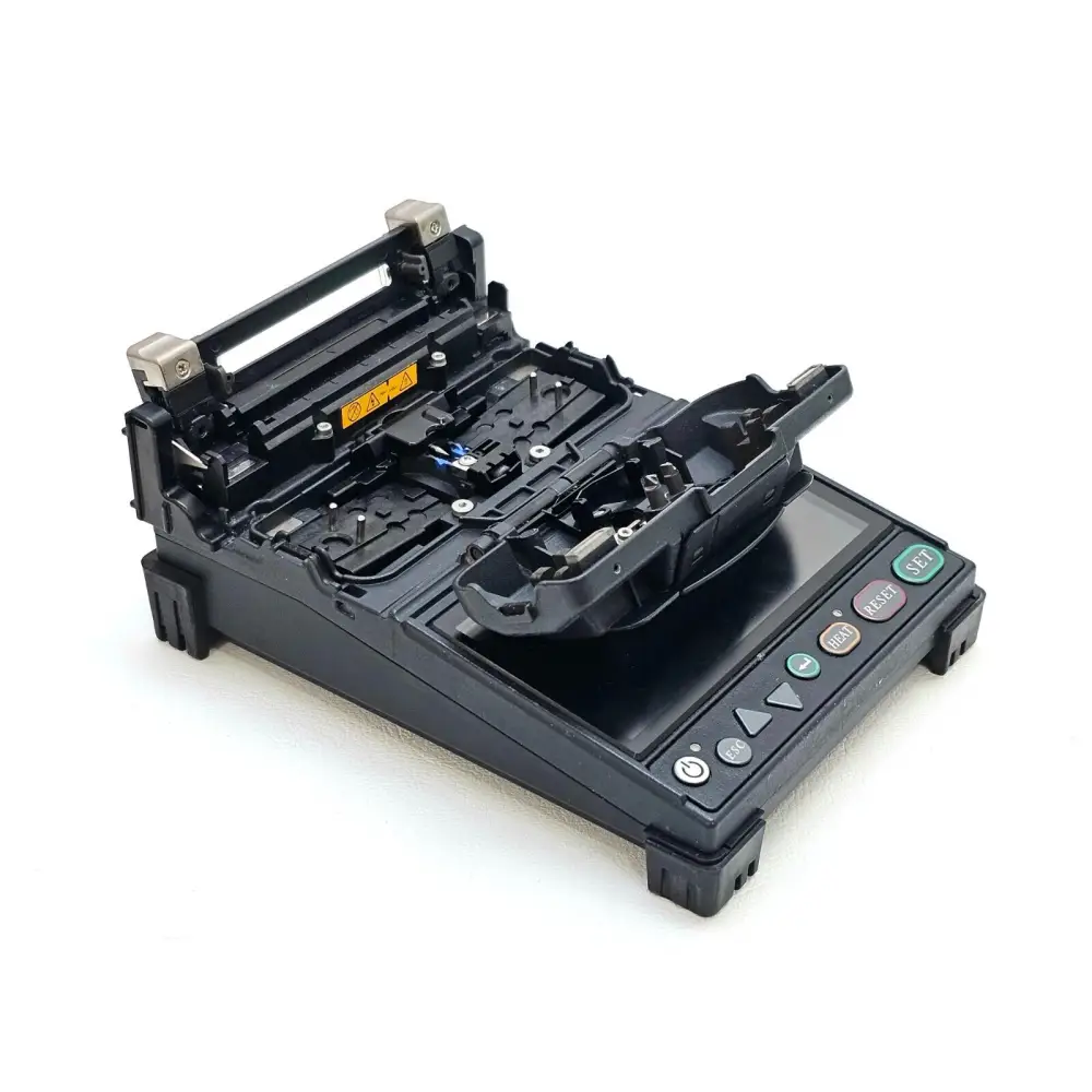 Fujikura 12S fusion splicer with lid open showing splicing chamber and electrodes