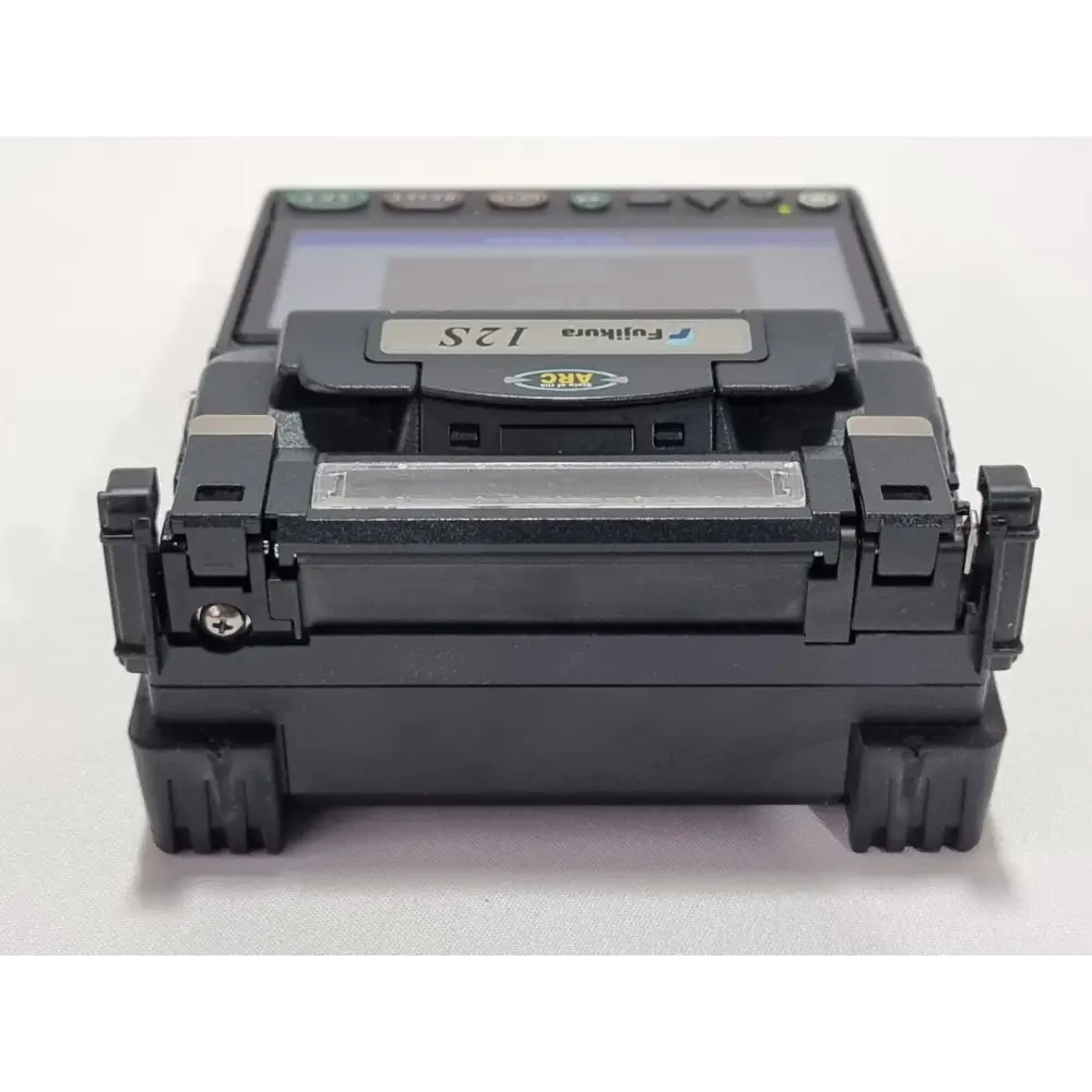 Fujikura 12S splicer splicing chamber close-up showing V-grooves and electrode assembly