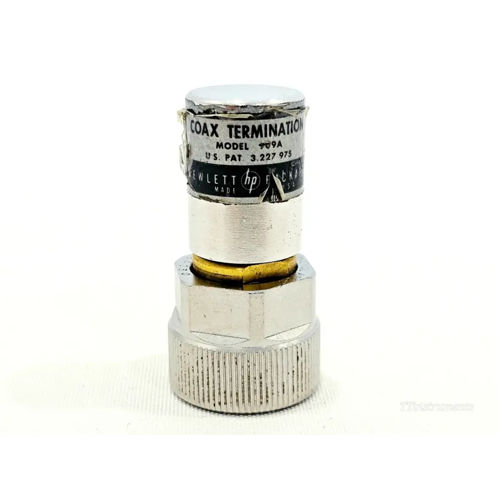 HP Agilent 909A APC-7 coaxial termination front view showing worn body label with model number and Hewlett-Packard branding