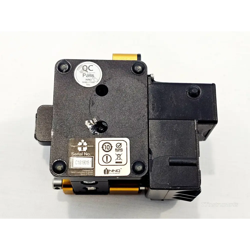 INNO V7 fibre cleaver underside showing serial number C1819015 label, QC Pass sticker, RoHS compliance and INNO Instrument branding