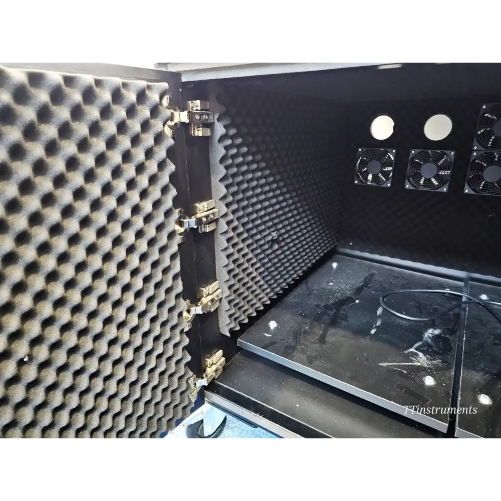 ionBench BCH120NE78 interior showing acoustic foam-lined door, internal cooling fans and exhaust ports on rear wall