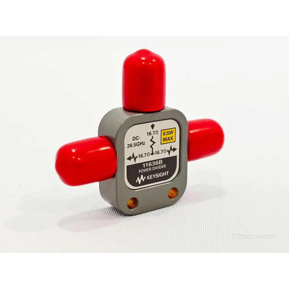 Keysight 11636B Power Divider front label view showing DC-26.5GHz, 16.7Ω, 0.5W MAX, red port caps fitted