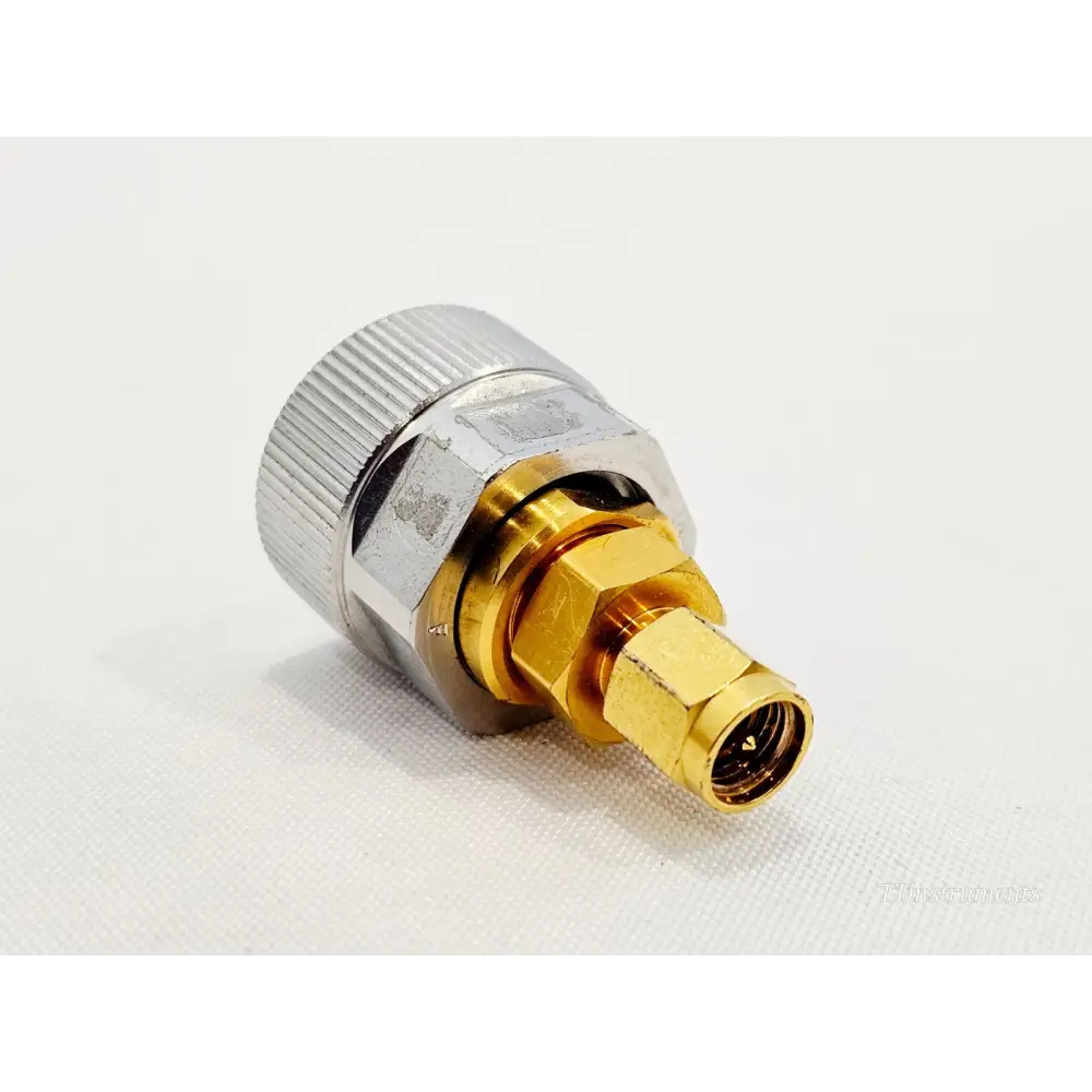 Keysight Agilent 1250-1746 APC-7 SMA adapter side view showing gold 3.5mm male SMA pin and threaded coupling sleeve