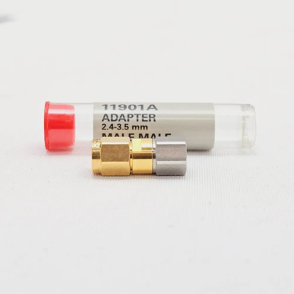 Keysight 11901A 2.4mm to 3.5mm male adapter beside labelled protective tube, side profile view