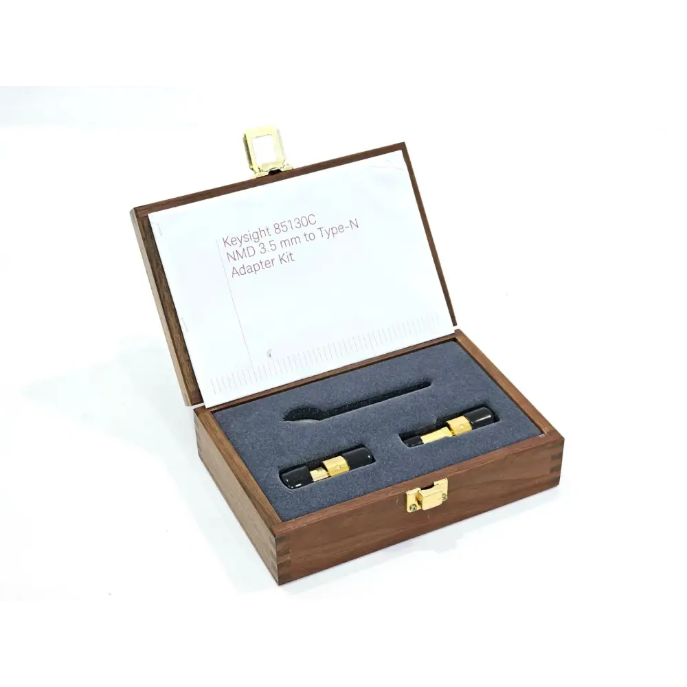 Keysight 85130C adapter kit open wooden presentation case showing two gold NMD 3.5mm Type-N adapters in foam