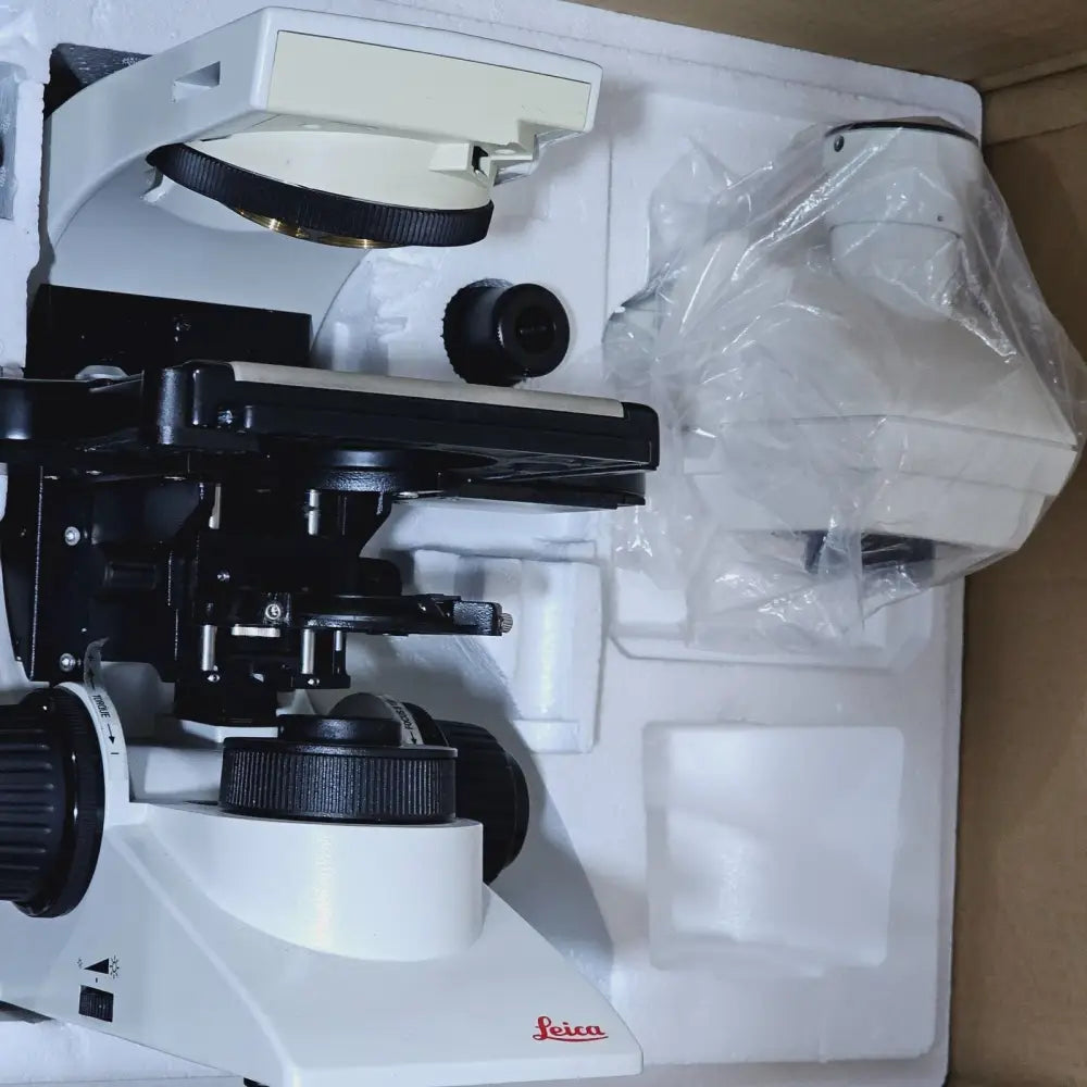 Leica DM2000 LED microscope left side view showing focus knobs and stage control