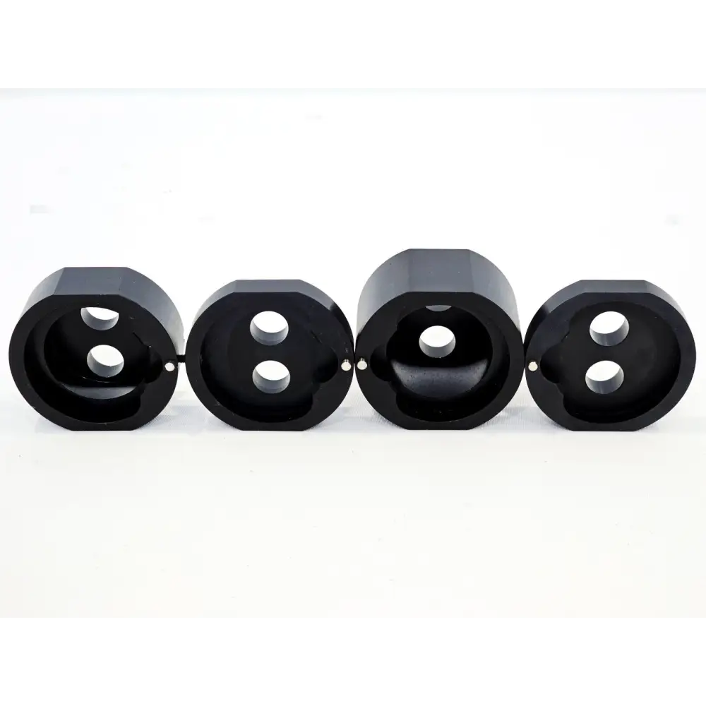 Four Lumenis Novus Spectra dual-port fibre optic aperture adapter inserts shown side by side, front view