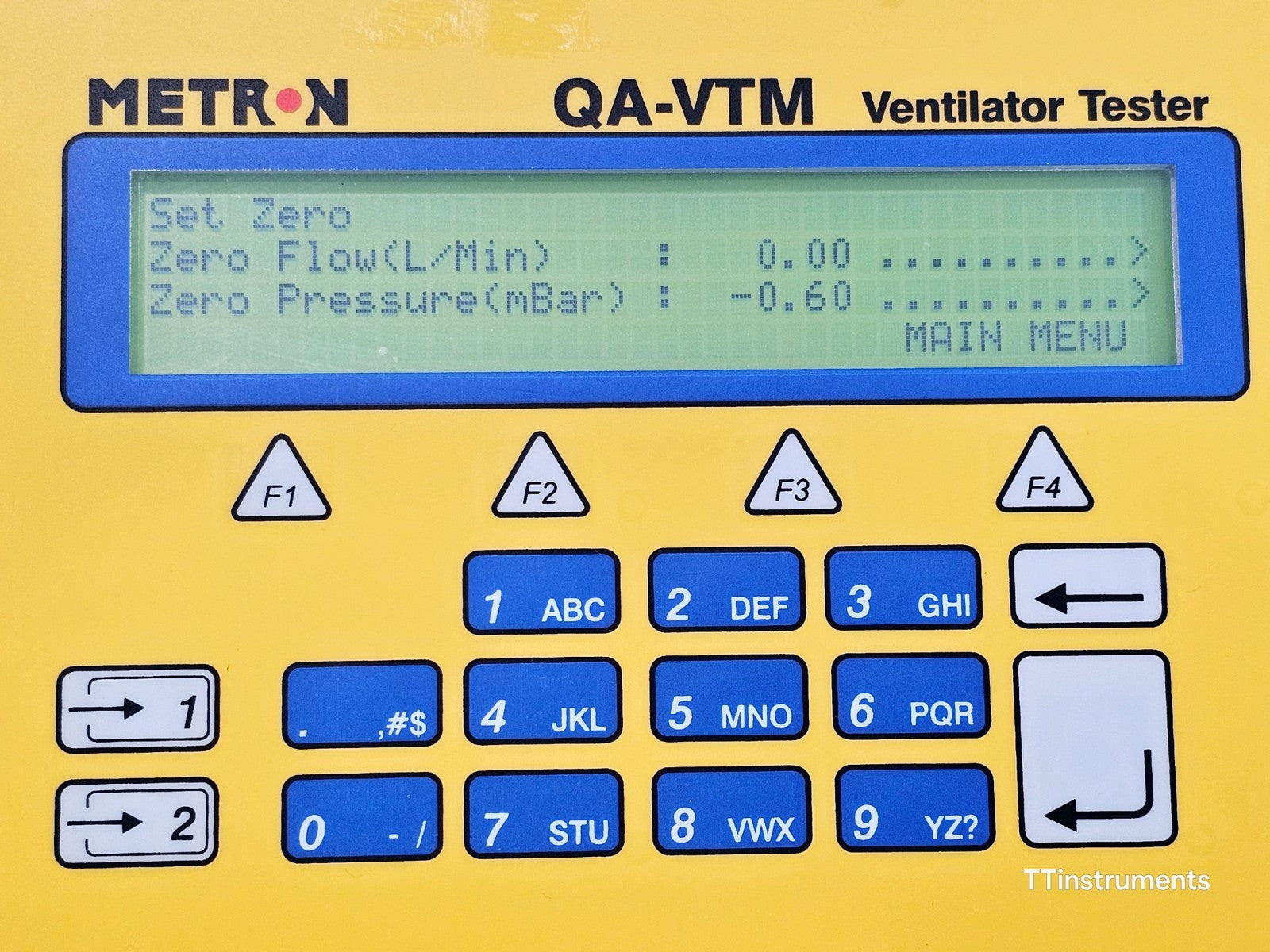 Metron QA-VTM LCD display close-up showing Set Zero menu with Zero Flow 0.00 L/Min and Zero Pressure -0.60 mBar