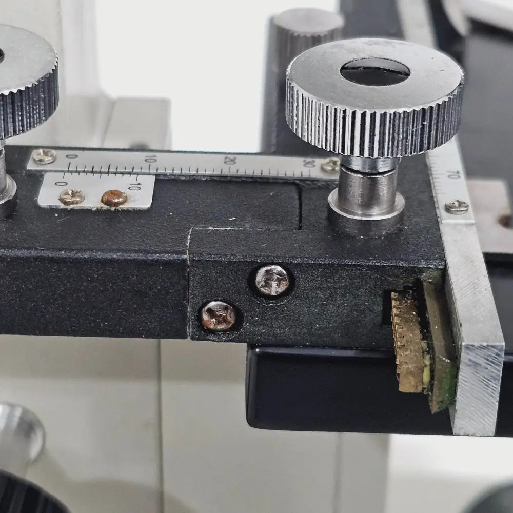 Close-up of 4/0.1 scanning objective lens on compound microscope revolving nosepiece