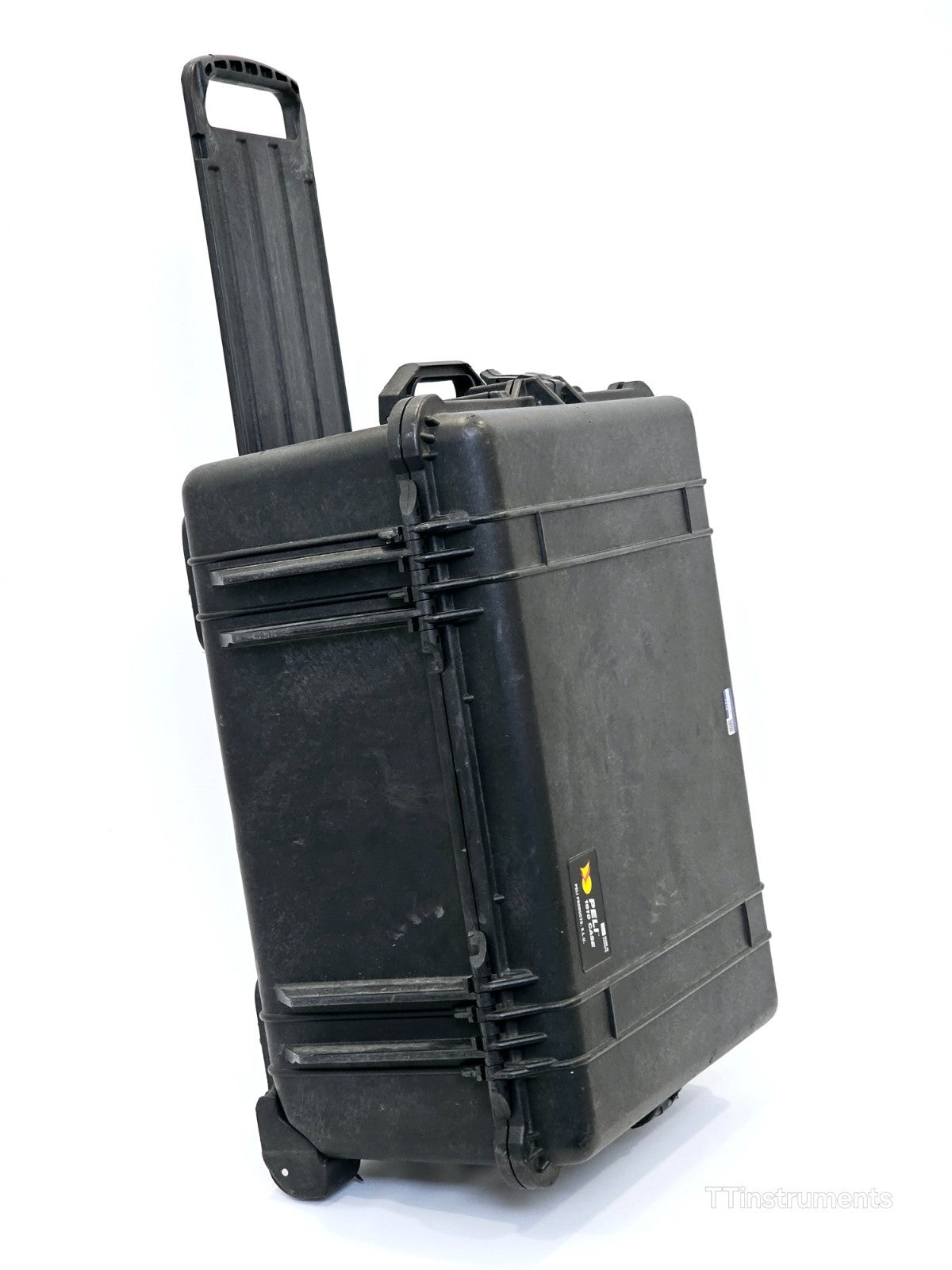 Pelican 1610 case side view showing wheels, latches and pressure relief valve