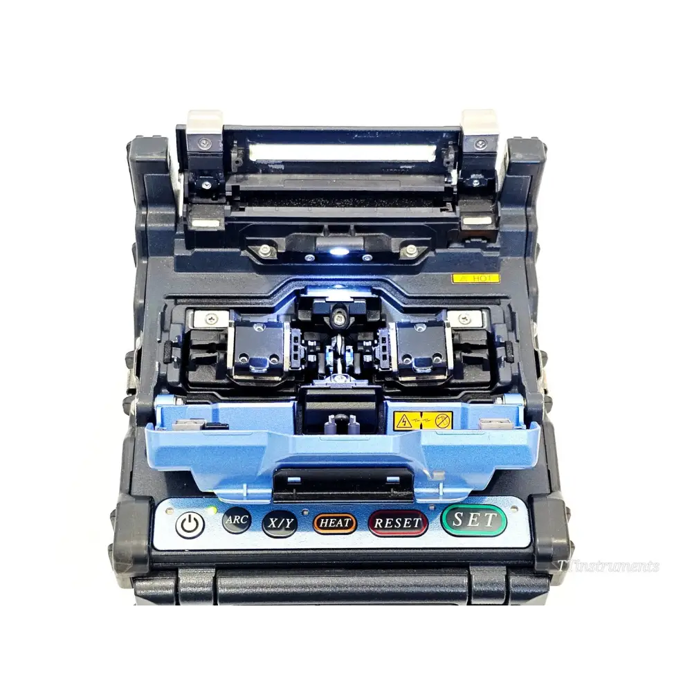 Fujikura FSM-62S+ top-down view showing fibre clamp V-grooves, electrodes and wind protector open ready for splicing