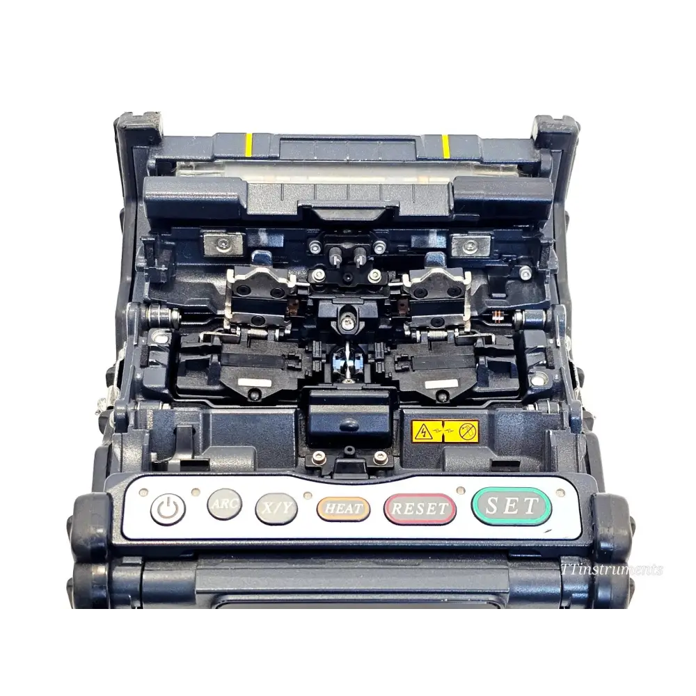 Fujikura FSM-70S fusion splicer top-down view showing open fibre splicing chamber with electrodes and v-groove clamps