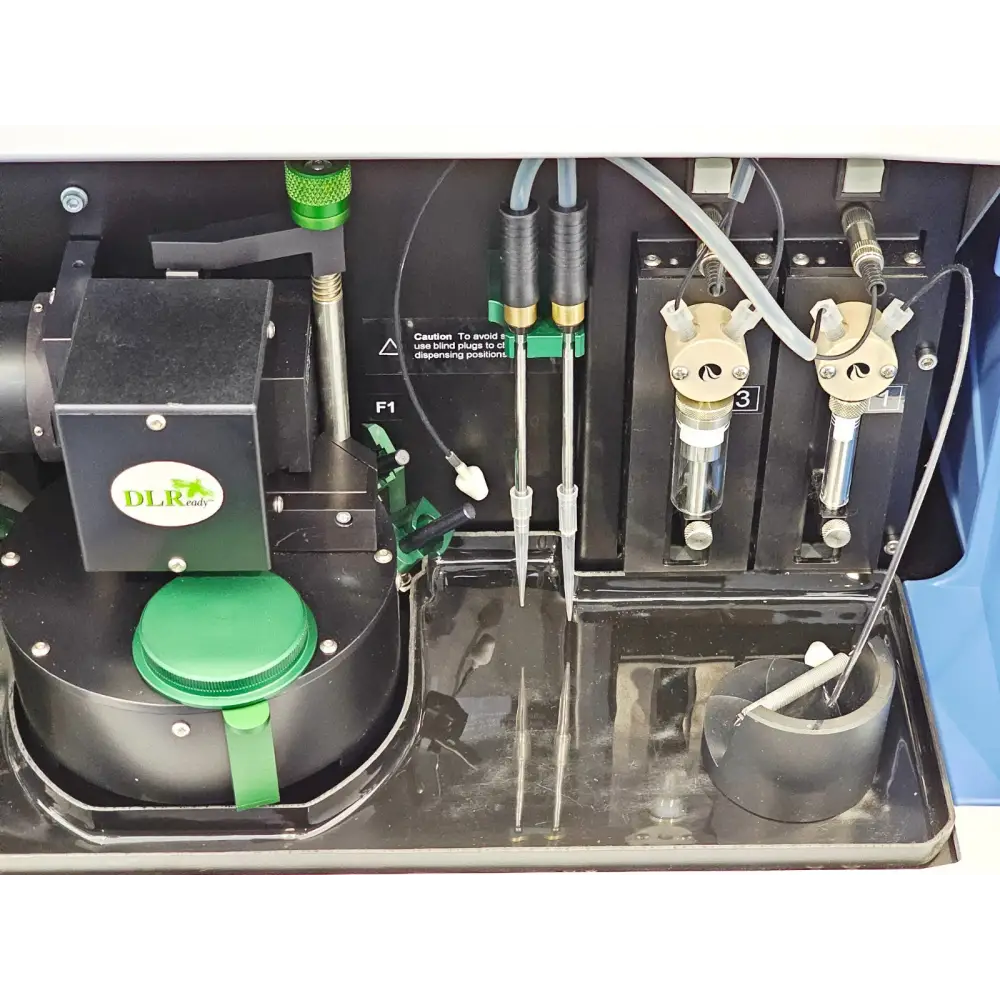 Varioskan Flash internal chamber close-up showing DLReady LumiSens module, dispensing needles, syringes and tubing