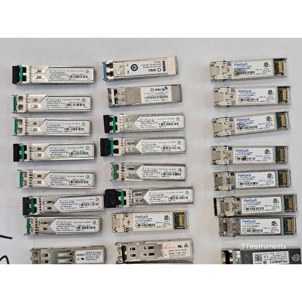 Close-up of assorted JDSU optical transceivers in untested job lot showing module labels