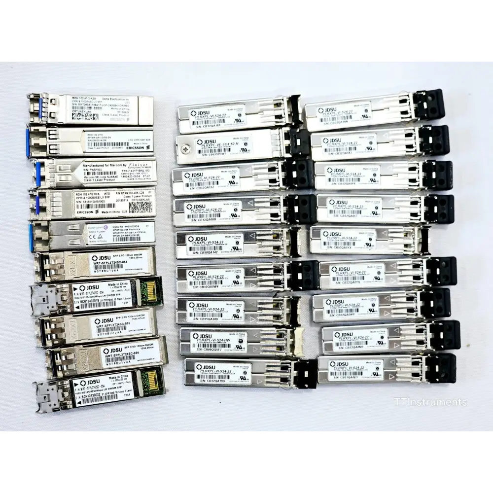 Close-up of assorted JDSU optical transceivers in untested job lot showing module labels