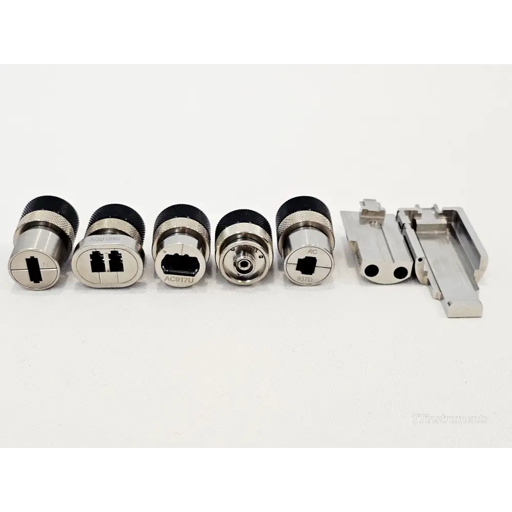 Six VIAVI mOPM-C1RHIS fibre adapter caps including AC917D, AC917U, SMA and MT bracket laid out in a row