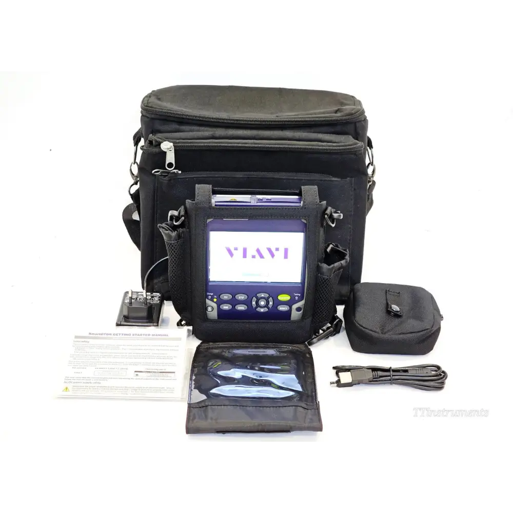 VIAVI SmartOTDR E118FA65 full kit overview — unit in carry case with AC adapter, USB cable, accessory pouch, manual, stylus