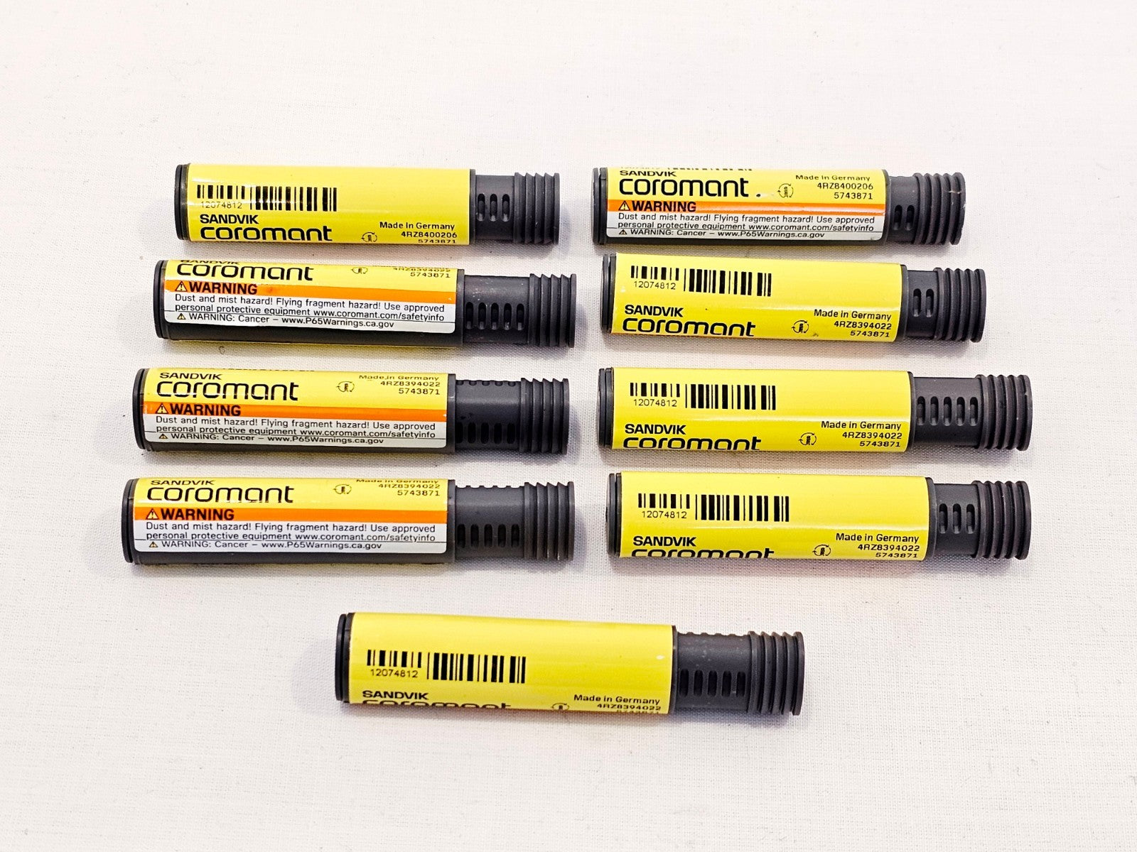 9x Sandvik Coromant R217.33C048280AC13N 1630 thread-milling end mills in yellow protective tubes, top view
