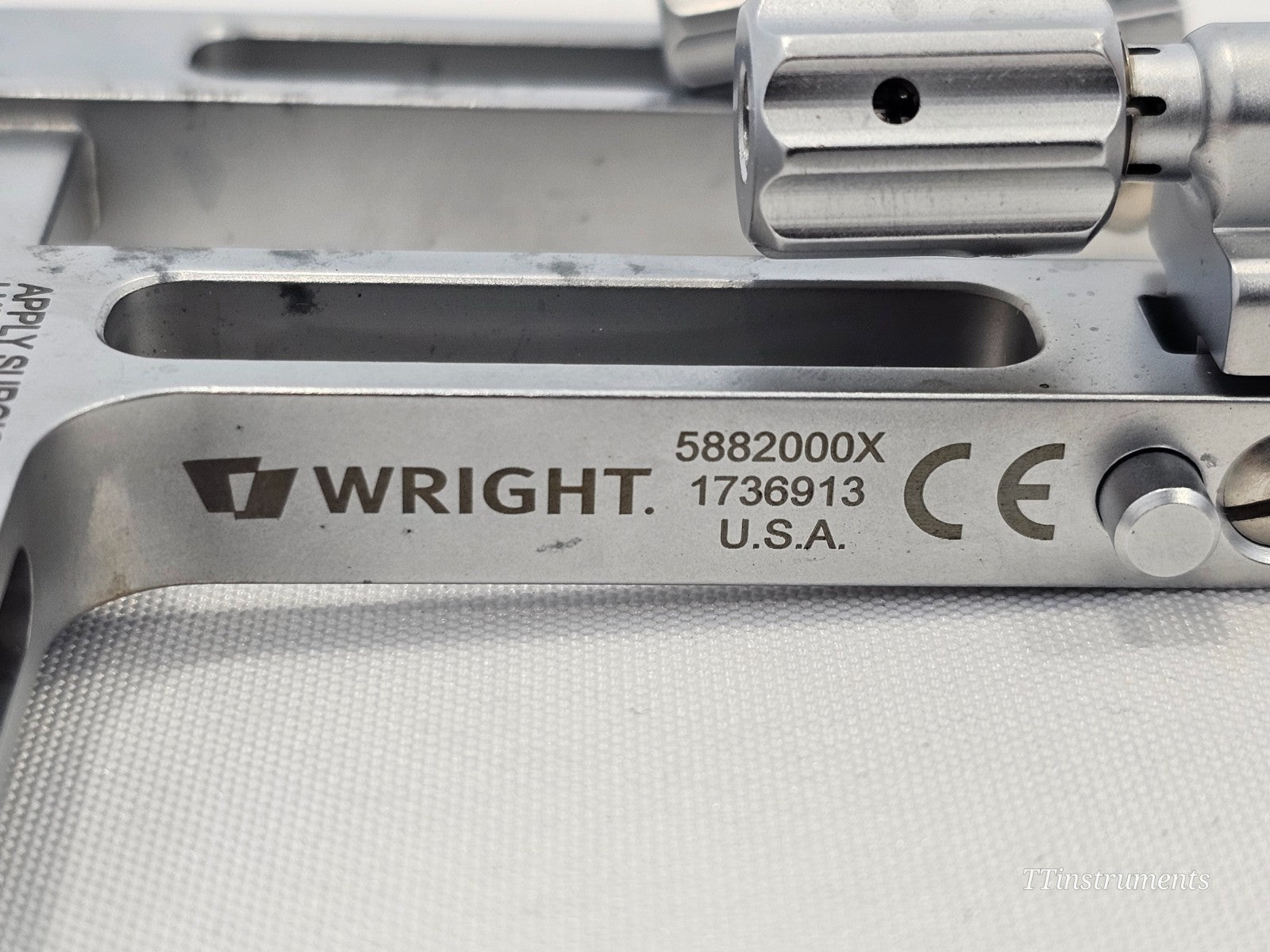 Close-up of Wright Medical X-Track 5882000X engraved label showing part number 5882000X, serial 1736913, CE mark, USA