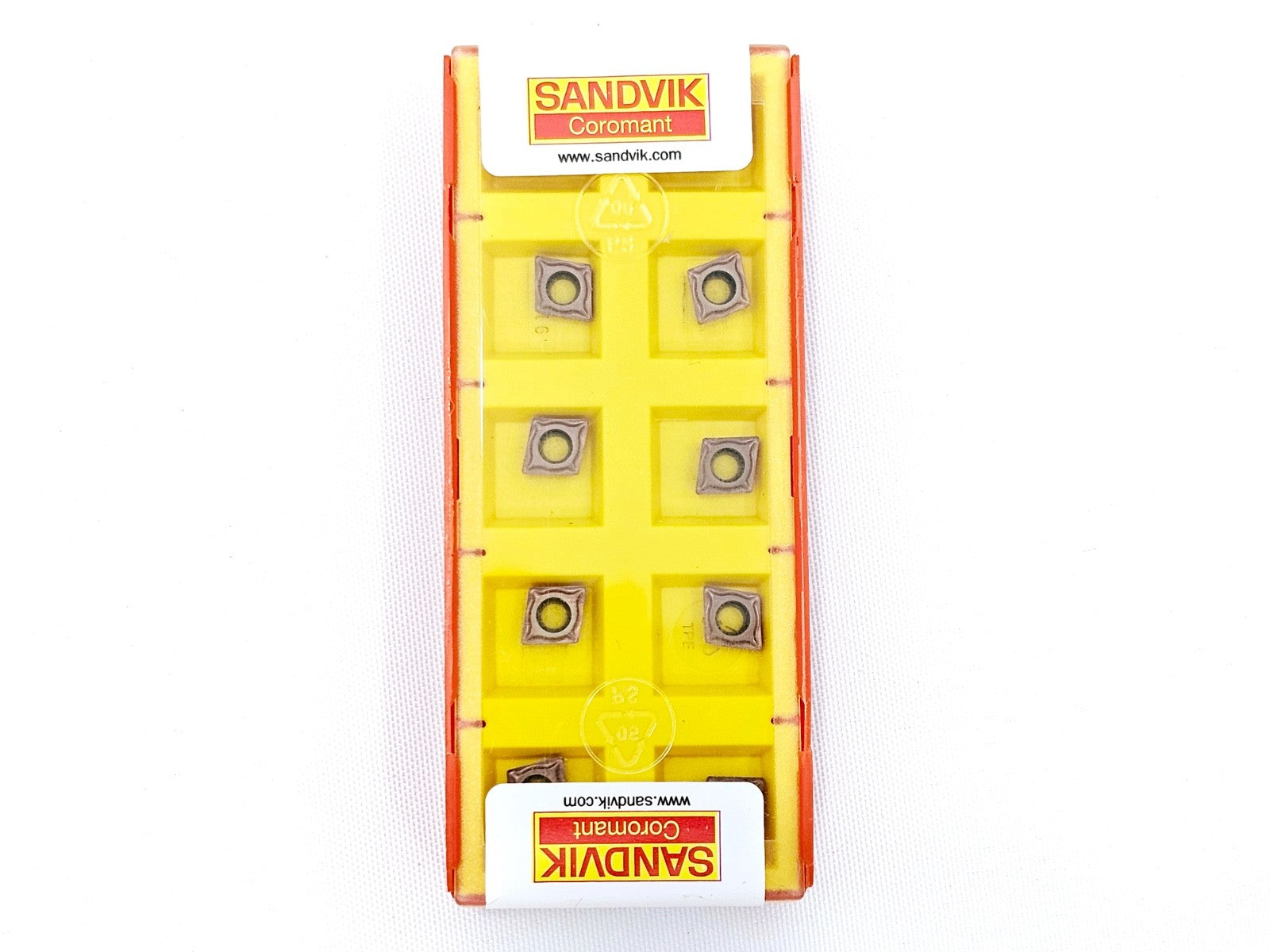 Sandvik Coromant CCMT 060204-UM 1115 yellow insert tray showing 7 carbide inserts, front view