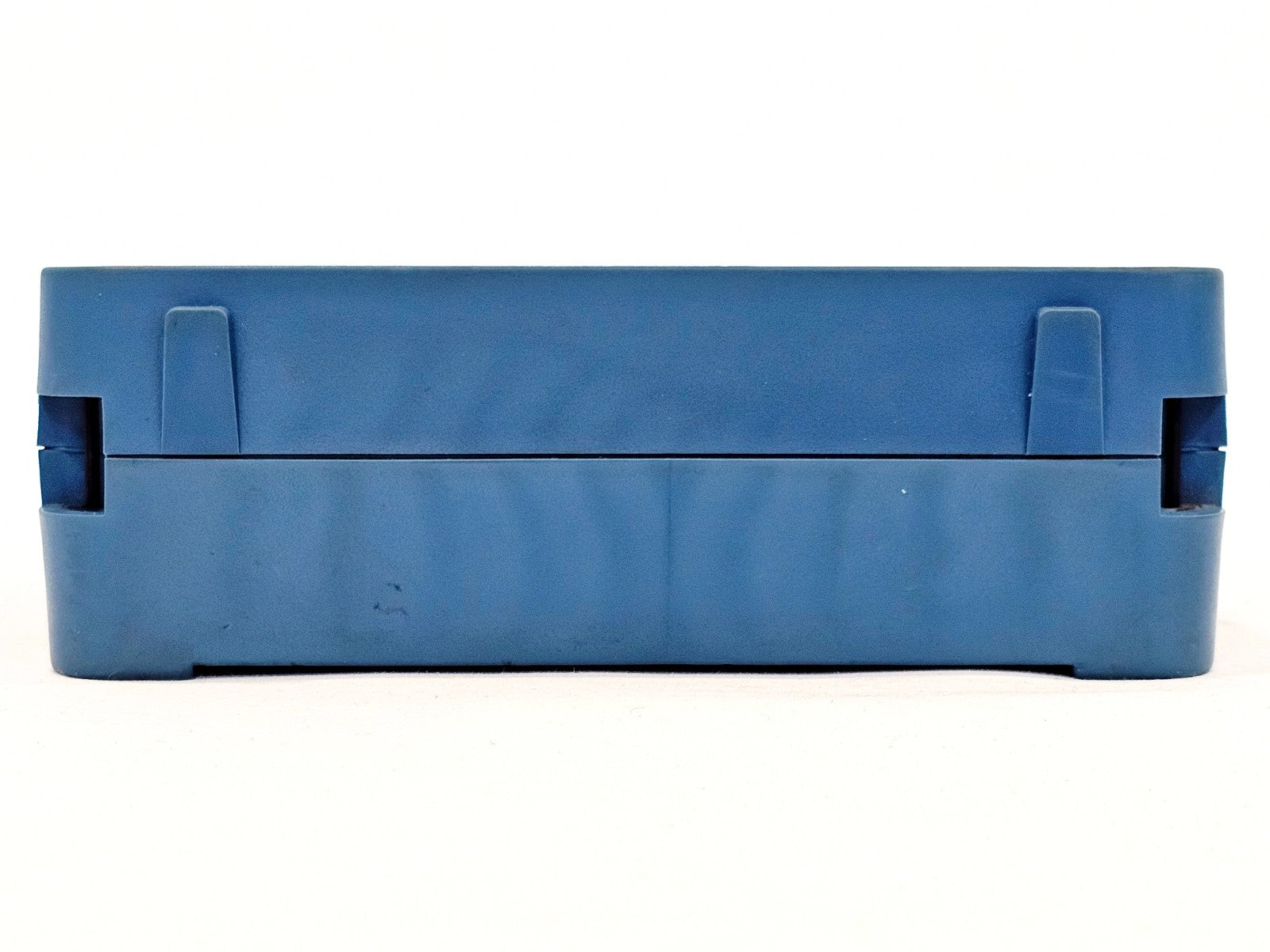 EXFO MAX-945-SM3 bottom view showing blue rubber housing and battery compartment seam with minor scuff marks