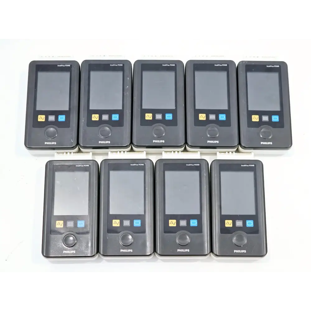 Nine Philips IntelliVue MX40 wearable monitors with screen off, front view showing colour touchscreen and controls