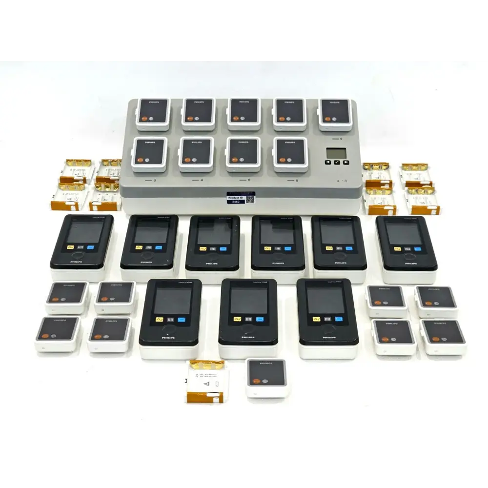 Full lot view: 9x Philips IntelliVue MX40-2B4 monitors, 865220 charging station, batteries, holders and ECG cables