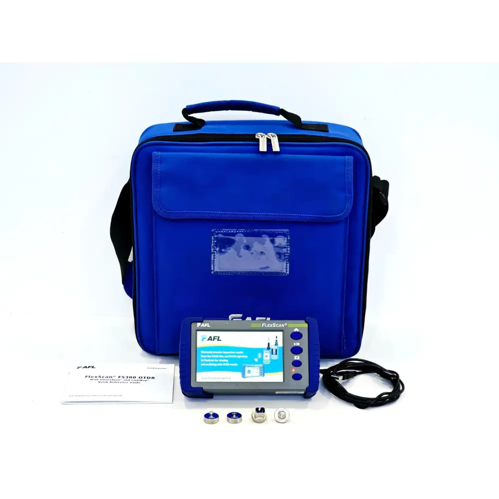 AFL FlexScan FS300-325 Quad OTDR complete kit laid out with blue carry bag, USB cable, port adapters and quick reference guide